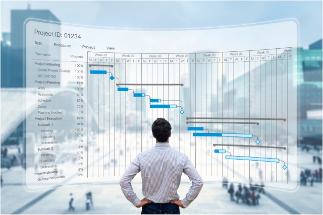 man standing in front of graphical view of Project chart